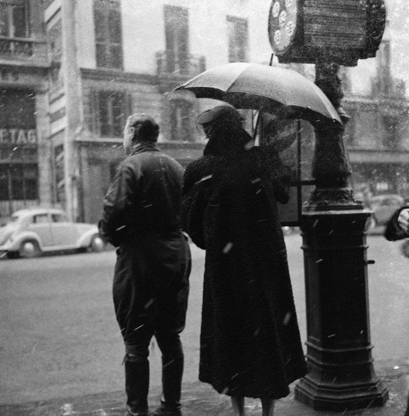 Parisians Waiting At A Bus Stop Under Snow, Paris, 1954.