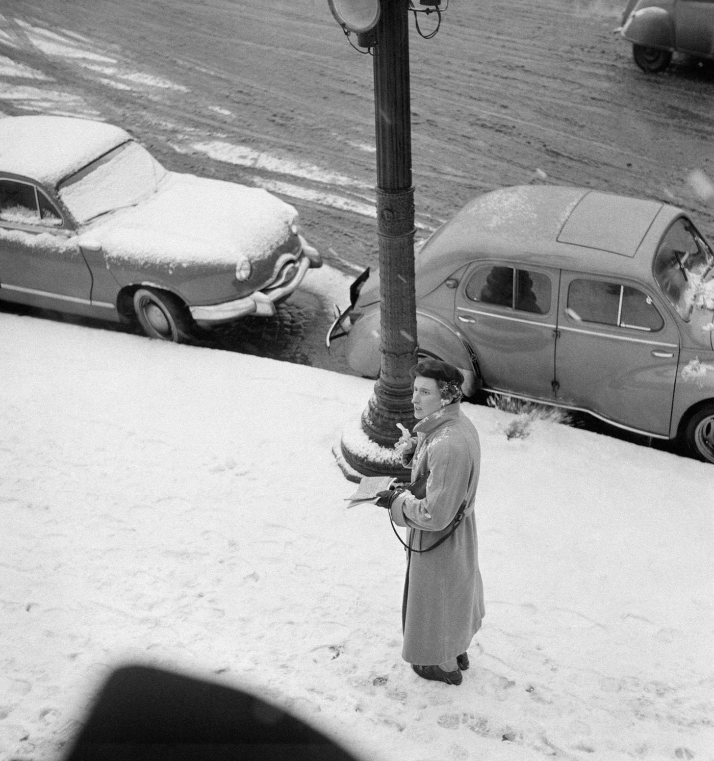 Elderly Woman Walking On A Snowy Sidewalk, Paris, January 1956.