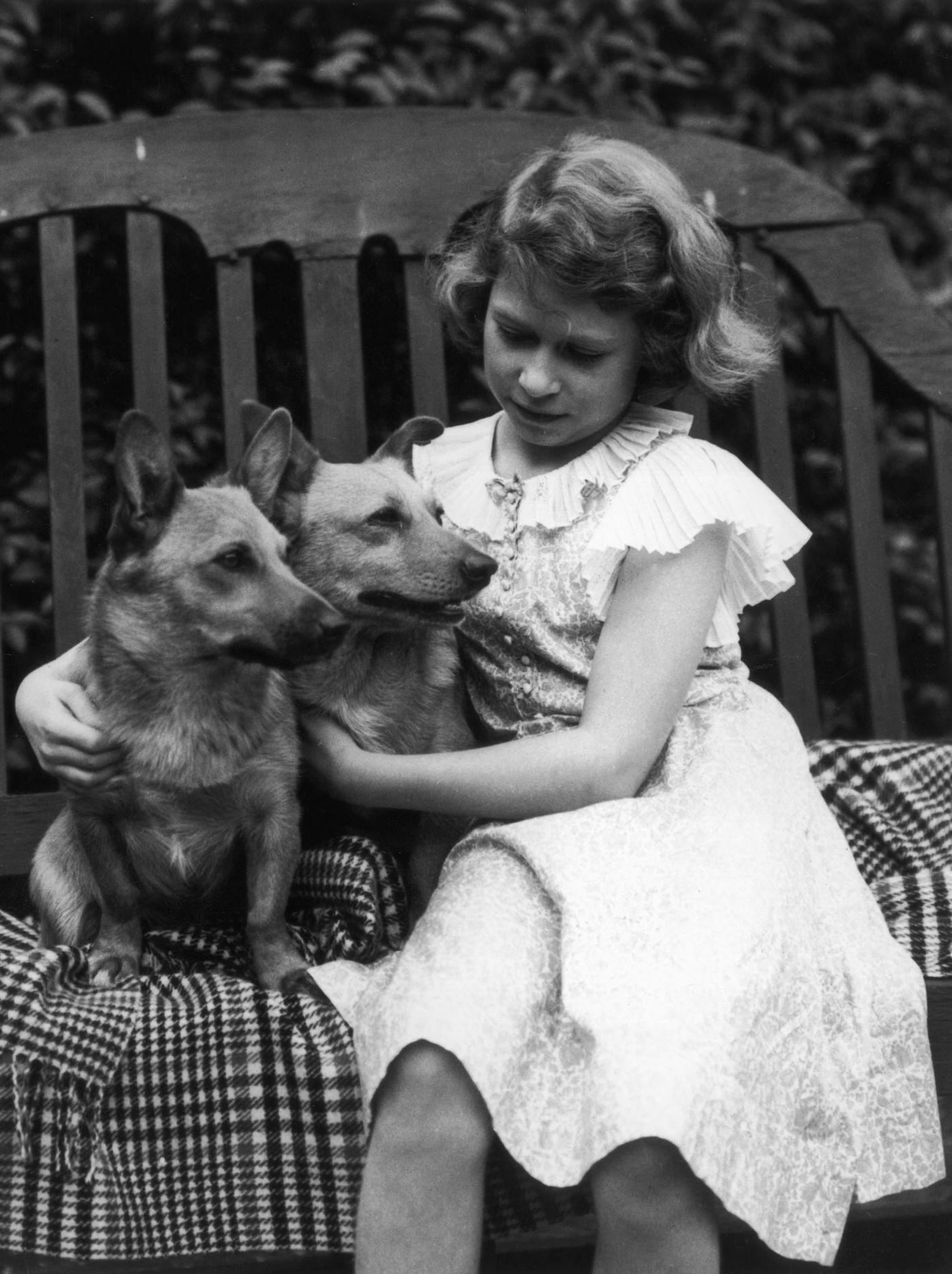 Princess Elizabeth in the grounds of her London home, 145 Piccadilly, with her pet corgis Jane and Dookie.