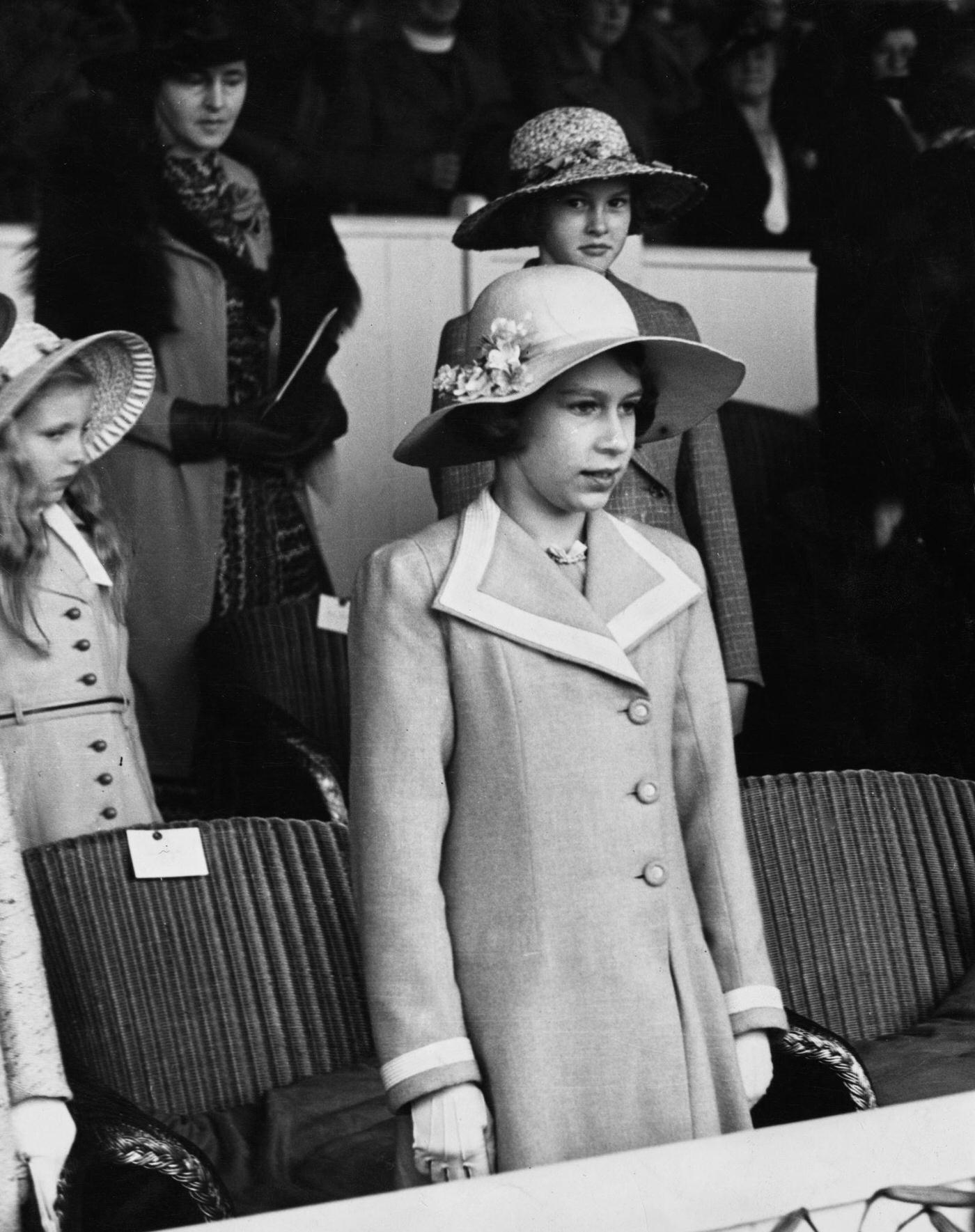 Princess Elizabeth standing for the national anthem during a dress rehearsal for the Aldershot Military Tattoo at Rushmoor Arena, Aldershot, Hampshire.