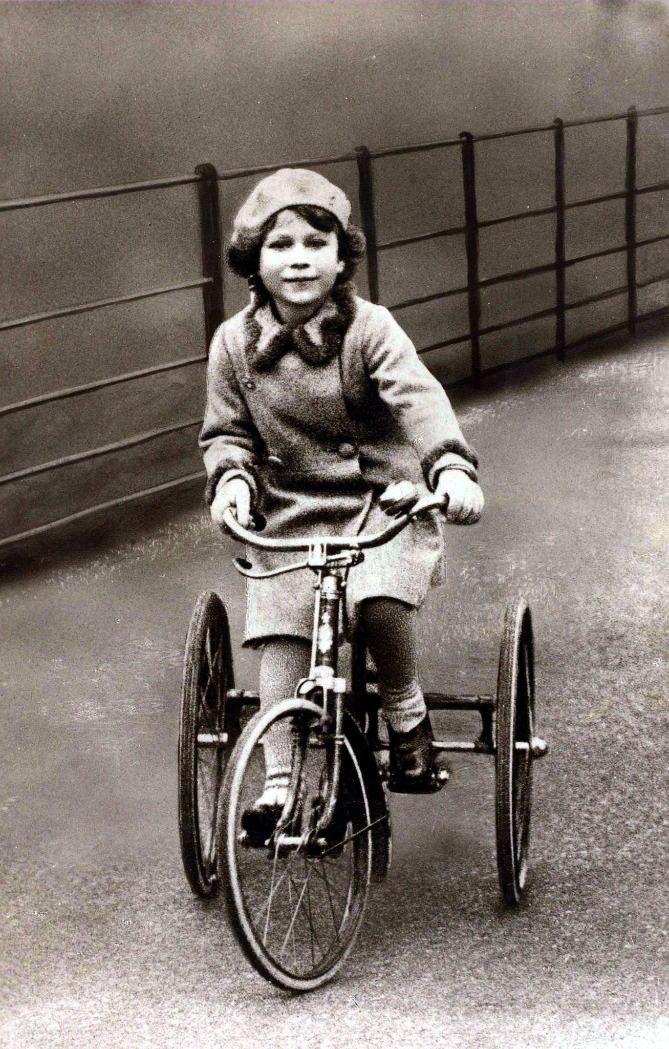 British Royalty, The young Princess Elizabeth is pictured riding on her tricycle, 1930.