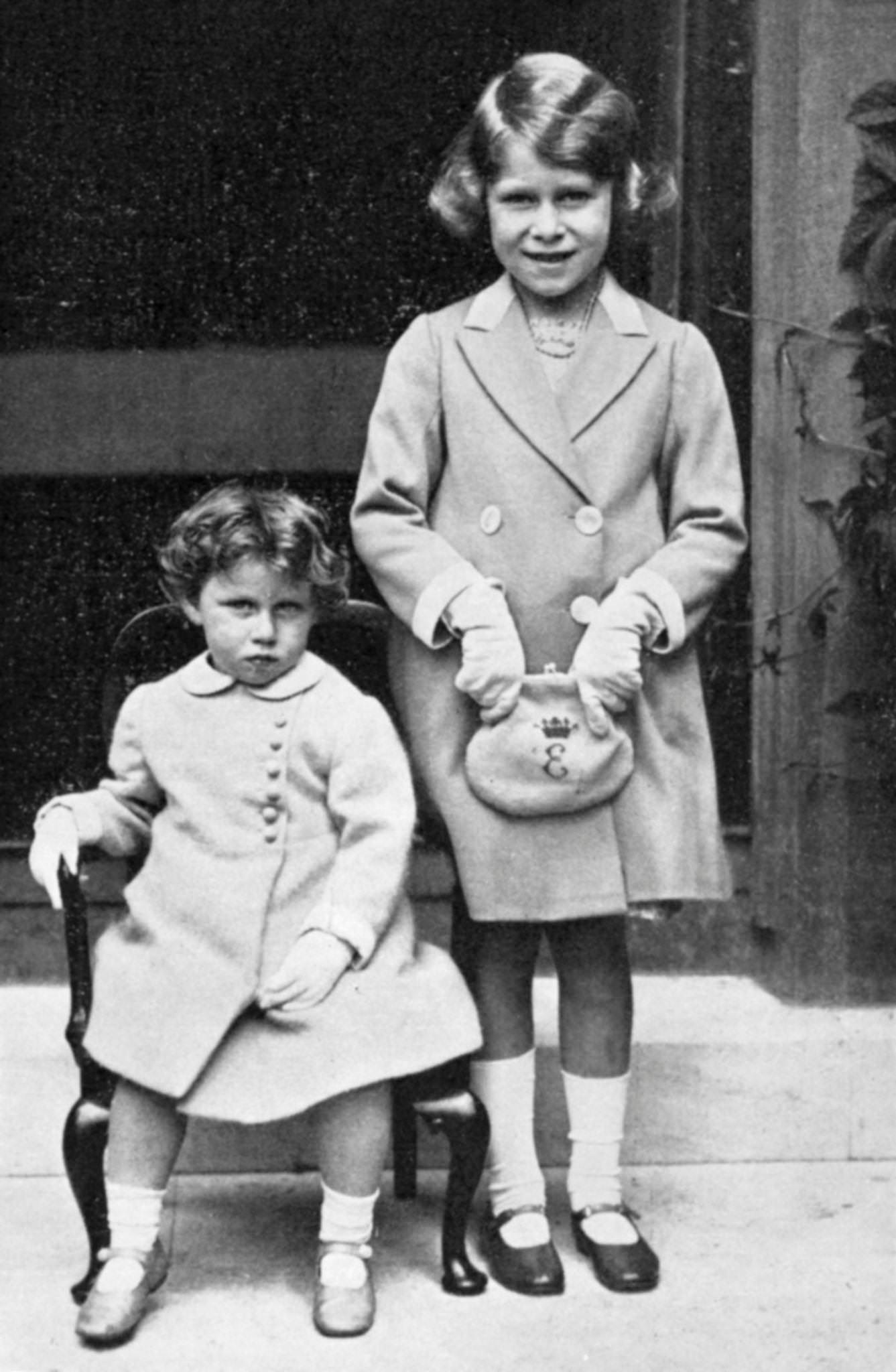 Princesses Elizabeth and Margaret standing together, with Elizabeth on the right and Margaret on the left.