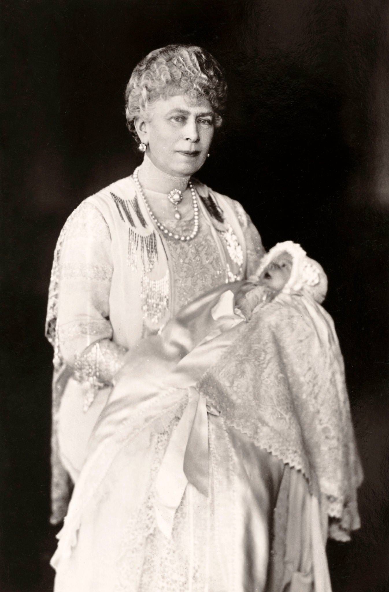 Queen Mary holding her grand-daughter, Princess Elizabeth Alexandra Mary who became Queen Elizabeth II, published in London, 1926.