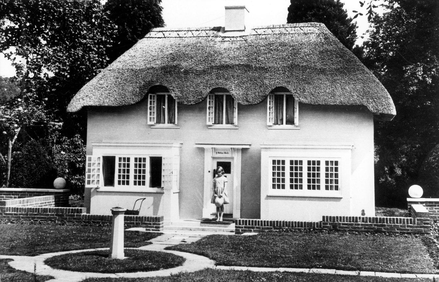 Queen Elizabeth II as a Seven-Year-Old in Front of Miniature House, 1933