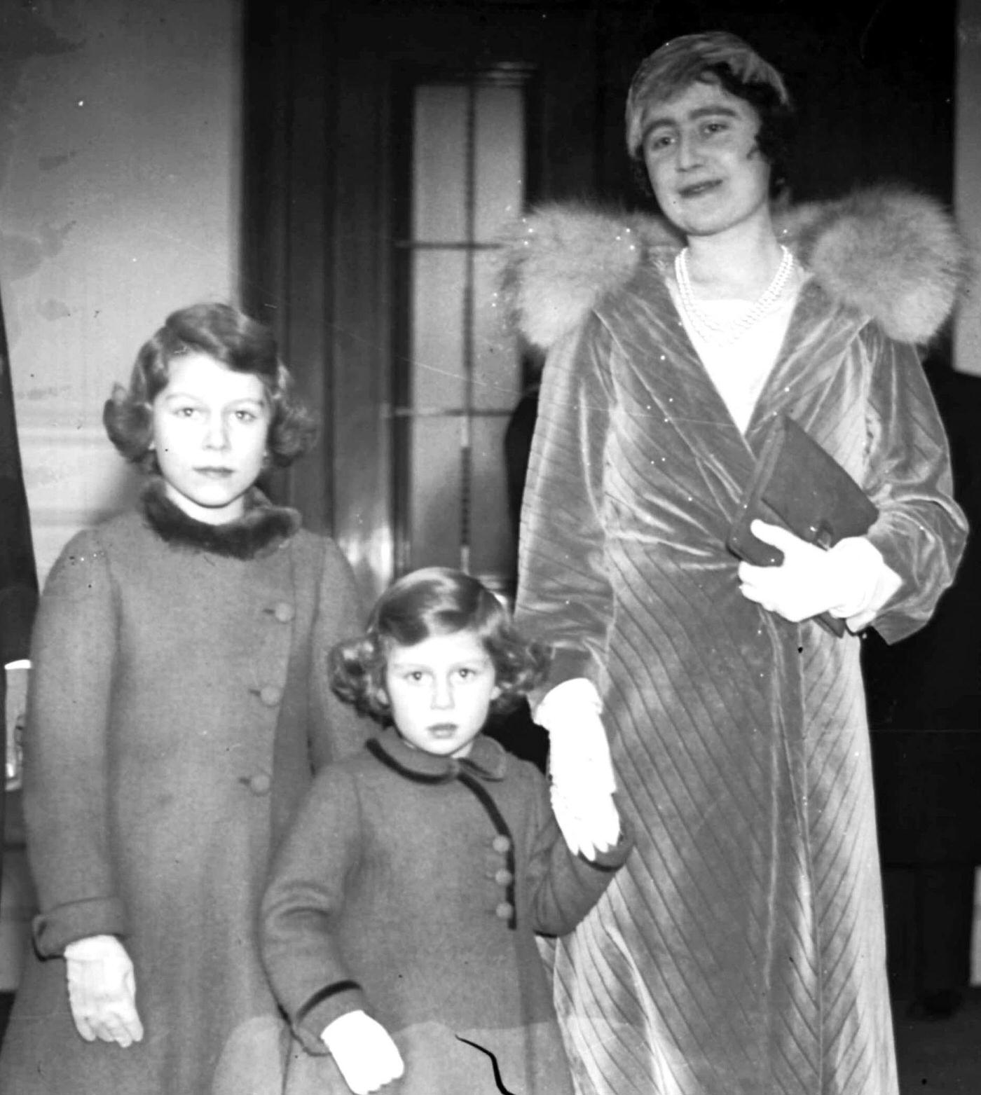 The Duchess of York (later the Queen Mother) arriving at London's Albert Hall with Princess Elizabeth and Princess Margaret to attend the Royal Choral Society's Christmas concert.