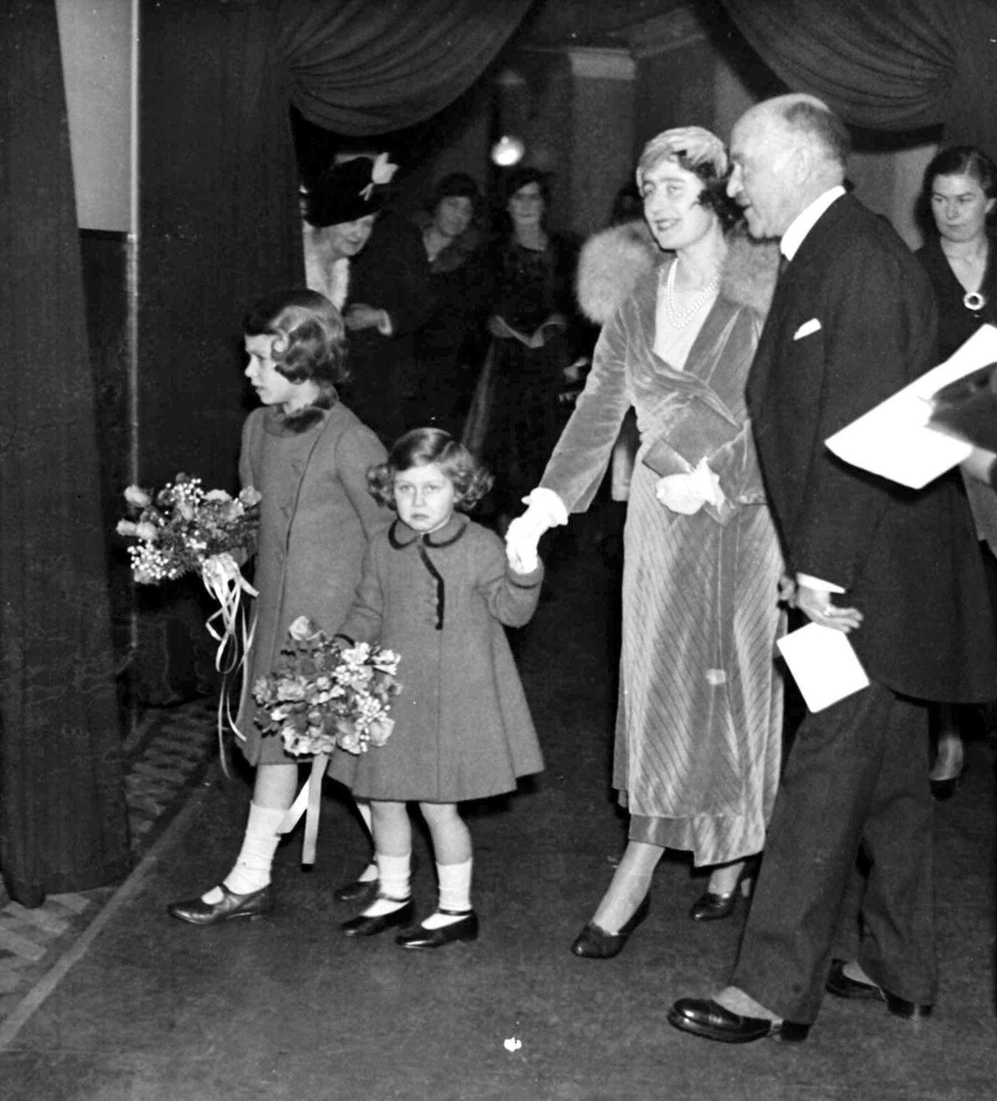 The Duchess of York (later the Queen Mother) arriving at London's Albert Hall with Princess Elizabeth and Princess Margaret to attend the Royal Choral Society's Christmas concert.
