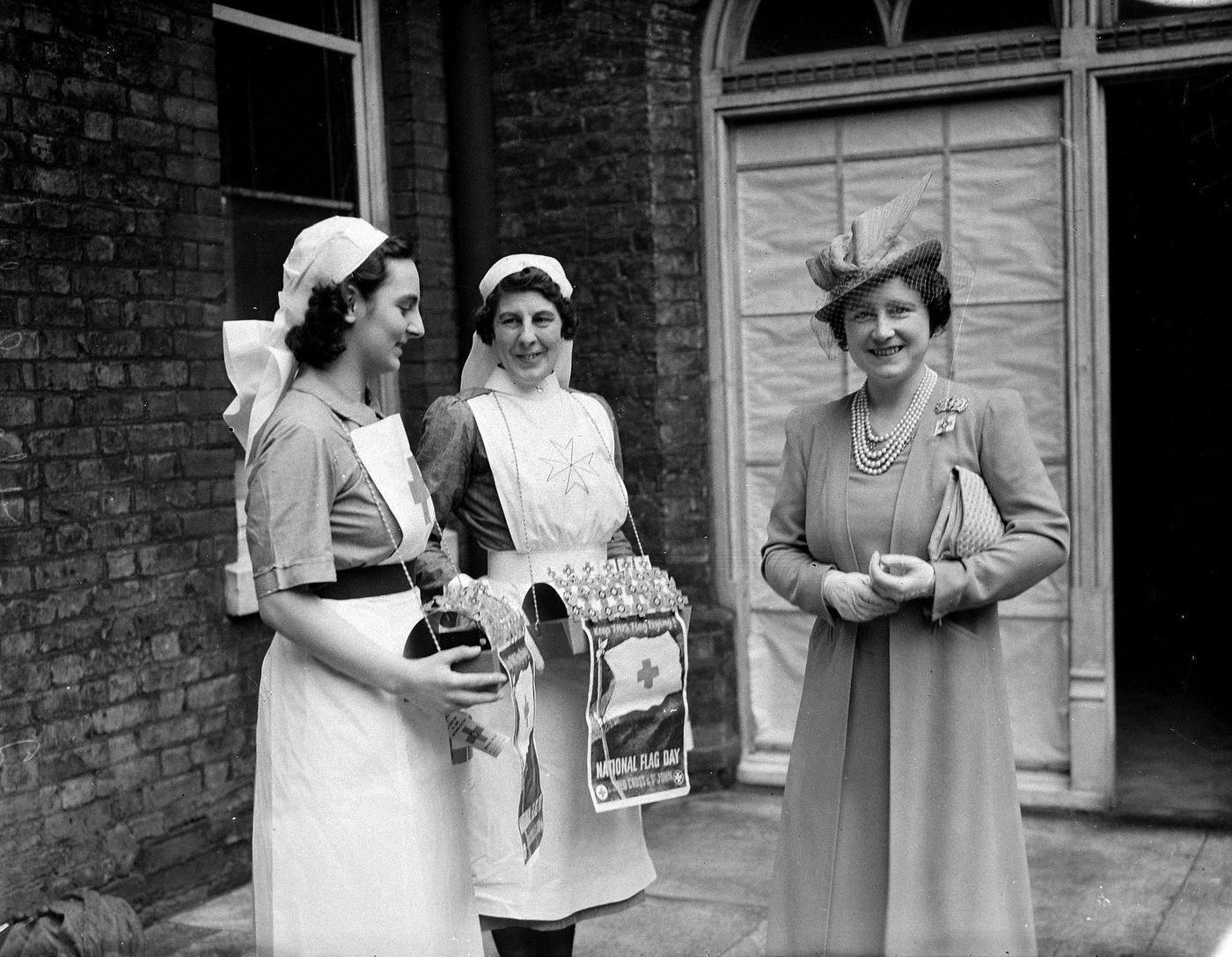 Queen Elizabeth lends her support to National Flag Day with two nurses selling tiny flags.