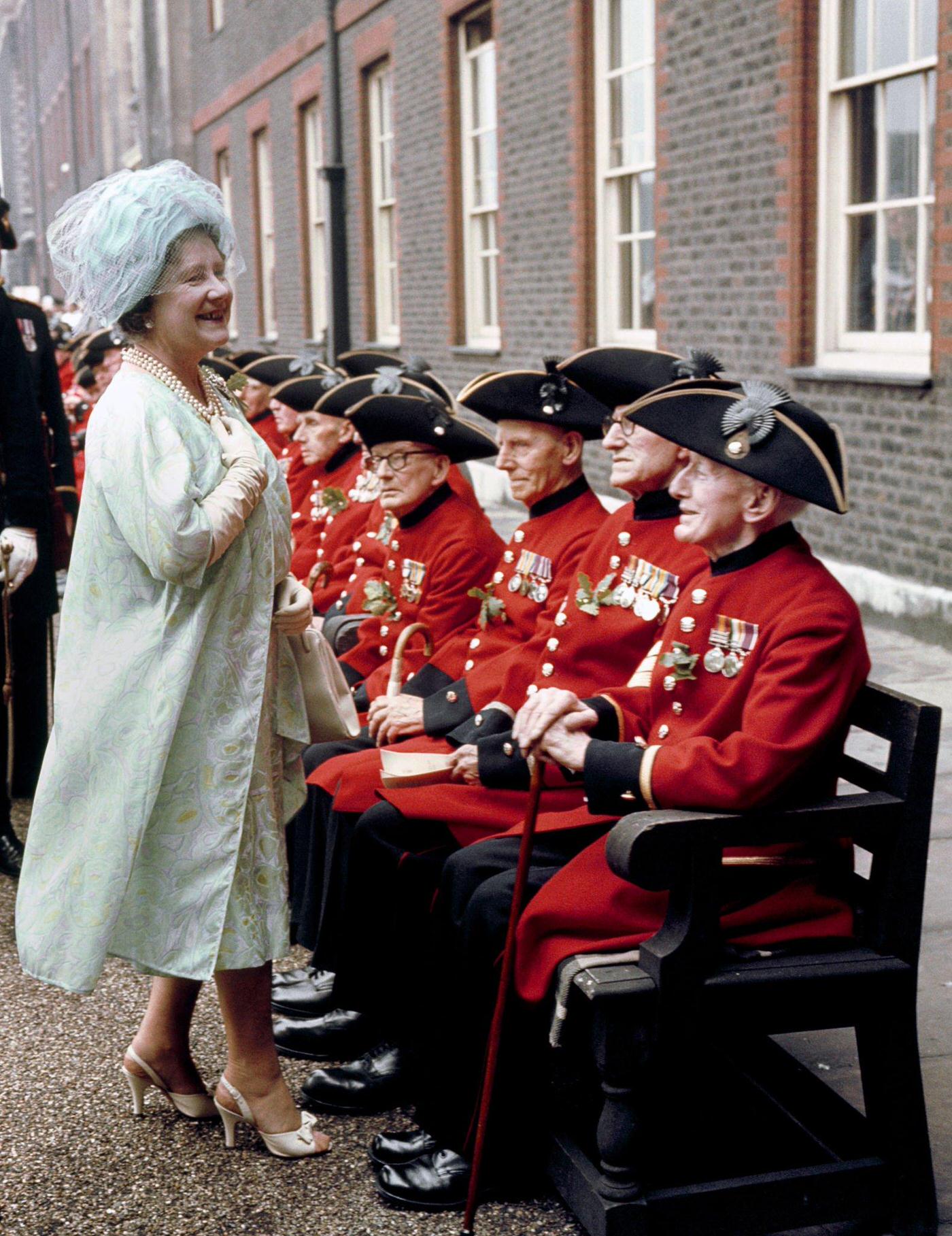 Queen Elizabeth, The Queen Mother, talks to Boer War veterans among Chelsea pensioners at their Founder's Day parade at the Royal Hospital, Chelsea, London, 1966.
