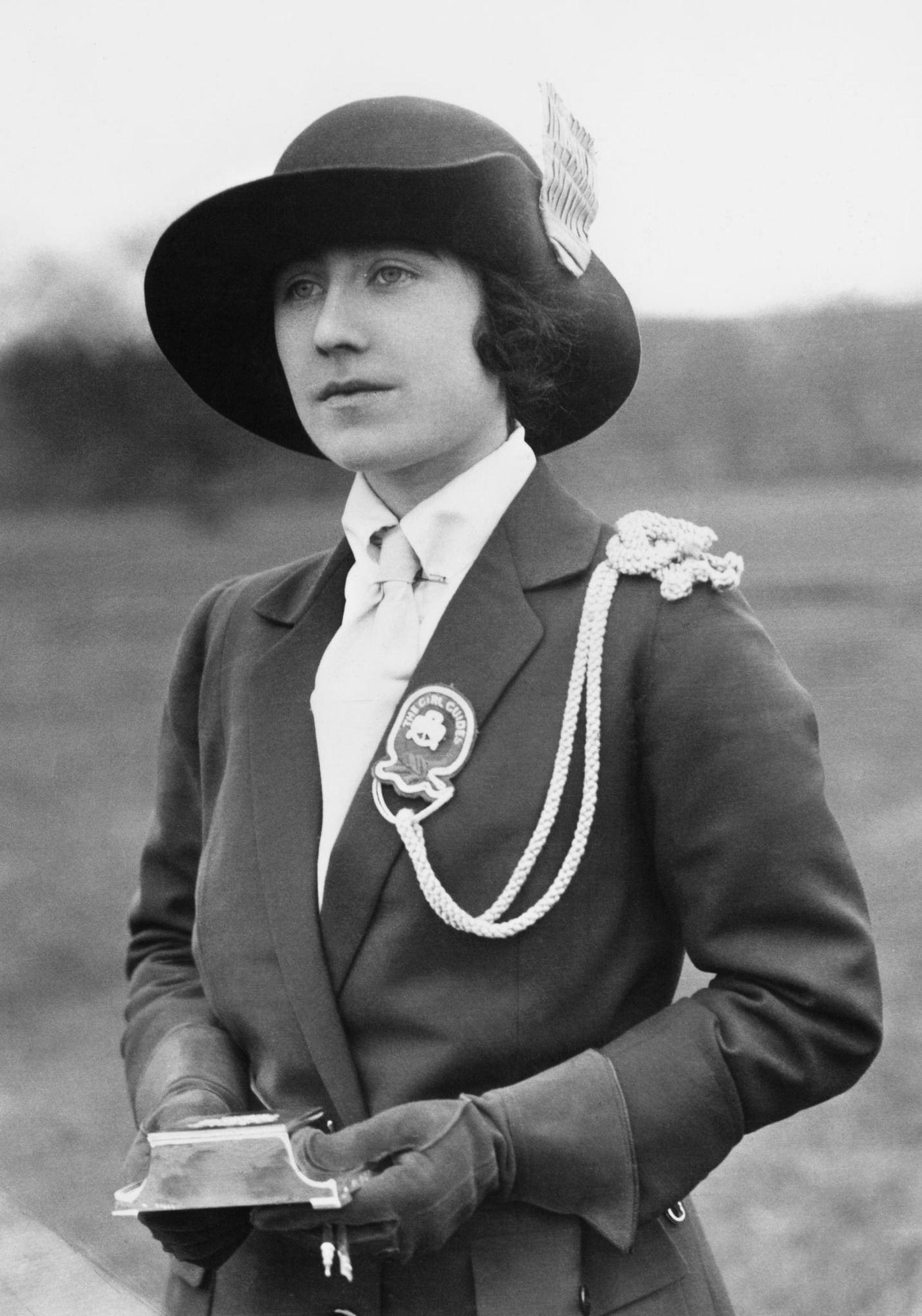 Lady Elizabeth Bowes-Lyon receives a gift from the 1st Glamis Company of Girl Guides, 1923.