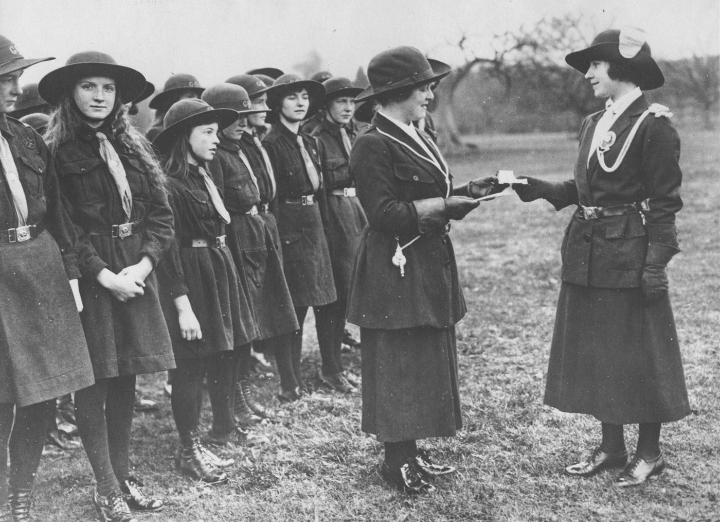 Lady Elizabeth Bowes-Lyon with silver ink stand and pens by members of the Glamis Girl Guides, of which she is the commissioner, Glamis, Angus, Scotland, 1923.