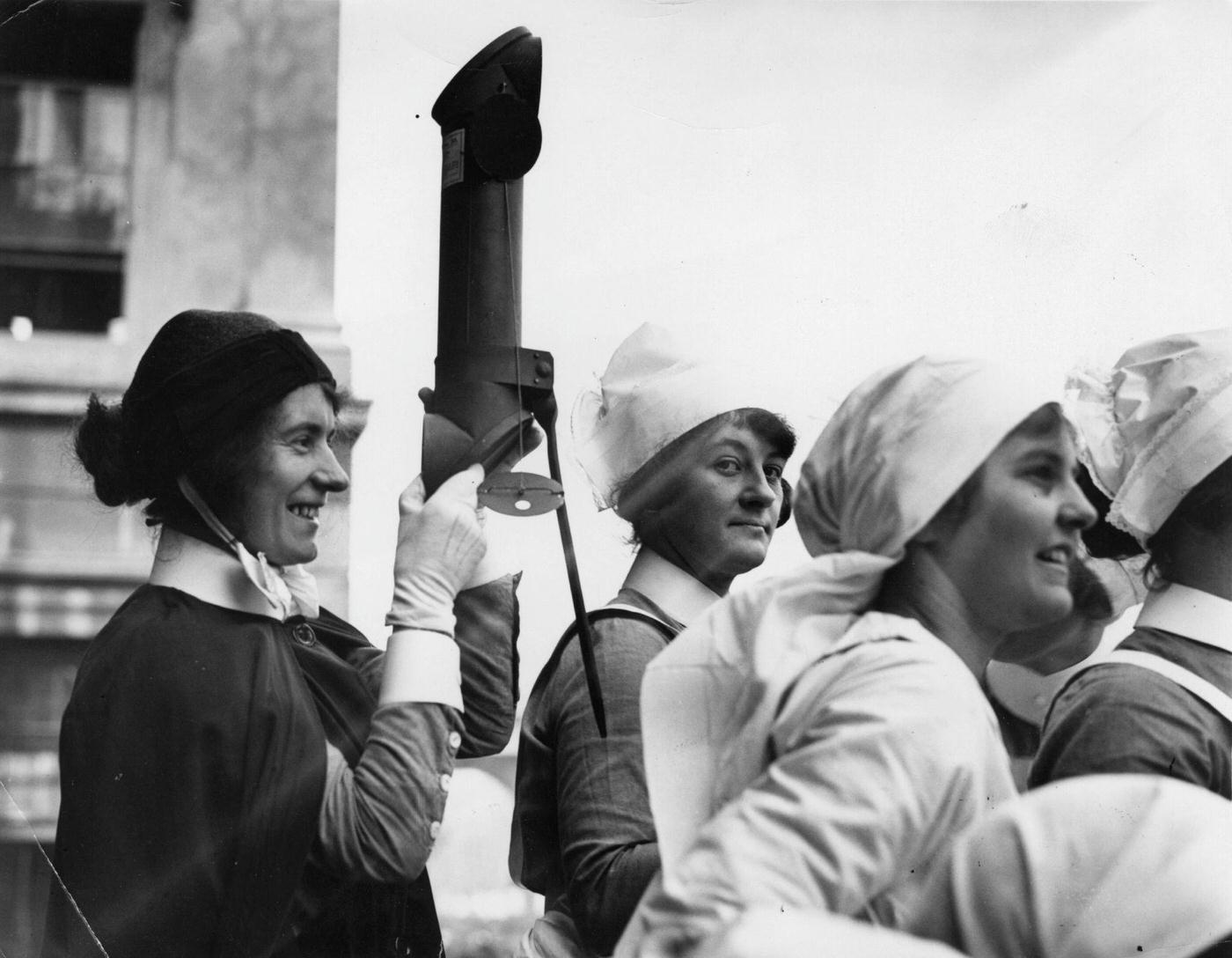 A nurse at St George's Hospital watching the procession at the wedding of George VI to Lady Elizabeth Bowes-Lyon, through a periscope.