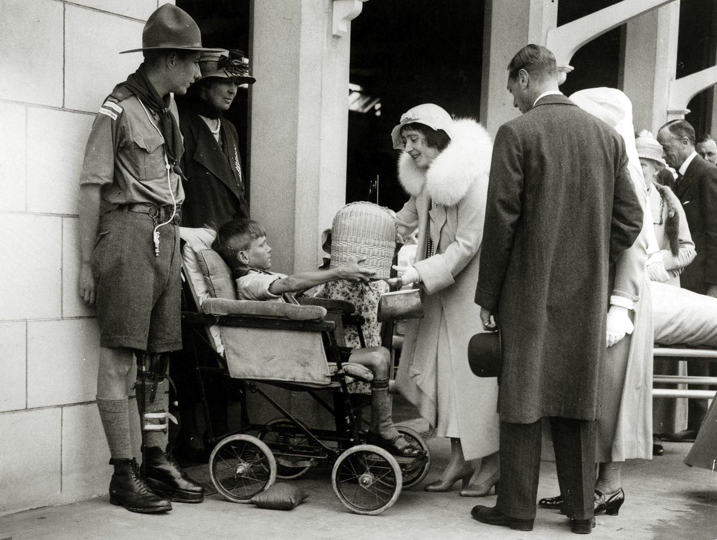 Duke and Duchess of York speaking with a disabled boy at the newly opened Royal United Orthopedic Hospital in Bath, 1933.