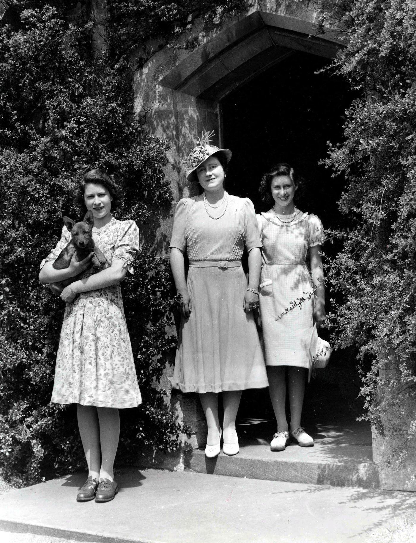 Queen Elizabeth with Princesses Margaret and Elizabeth and a Pembroke Welsh Corgi dog, Royal Lodge, Windsor Great Park, 1940.