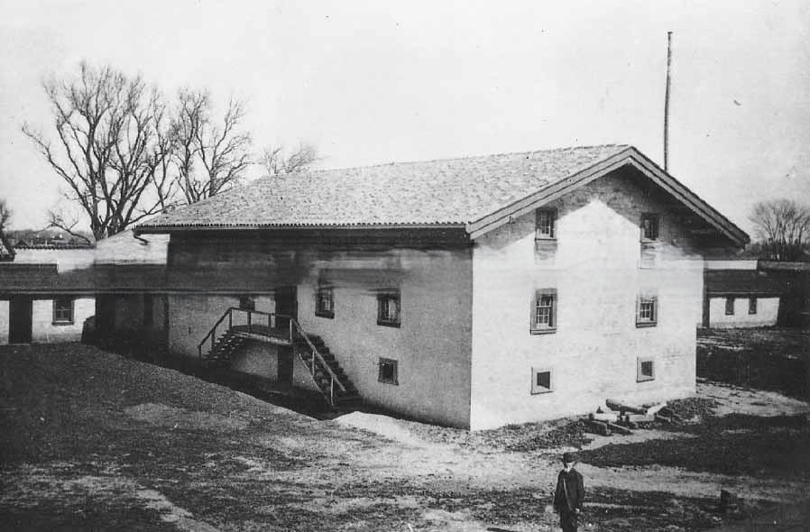 Sutter's Fort shortly after restoration, interior view of grounds showing central building, 1891