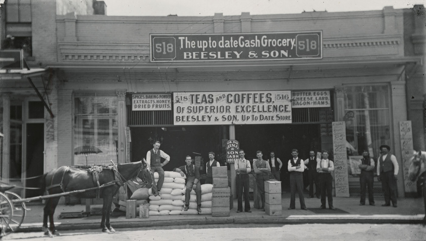 Beesley & Son (Albert V. and Charles A.) grocery store located at 518 J Steet. Shows bags and boxes stacked in front, 1896