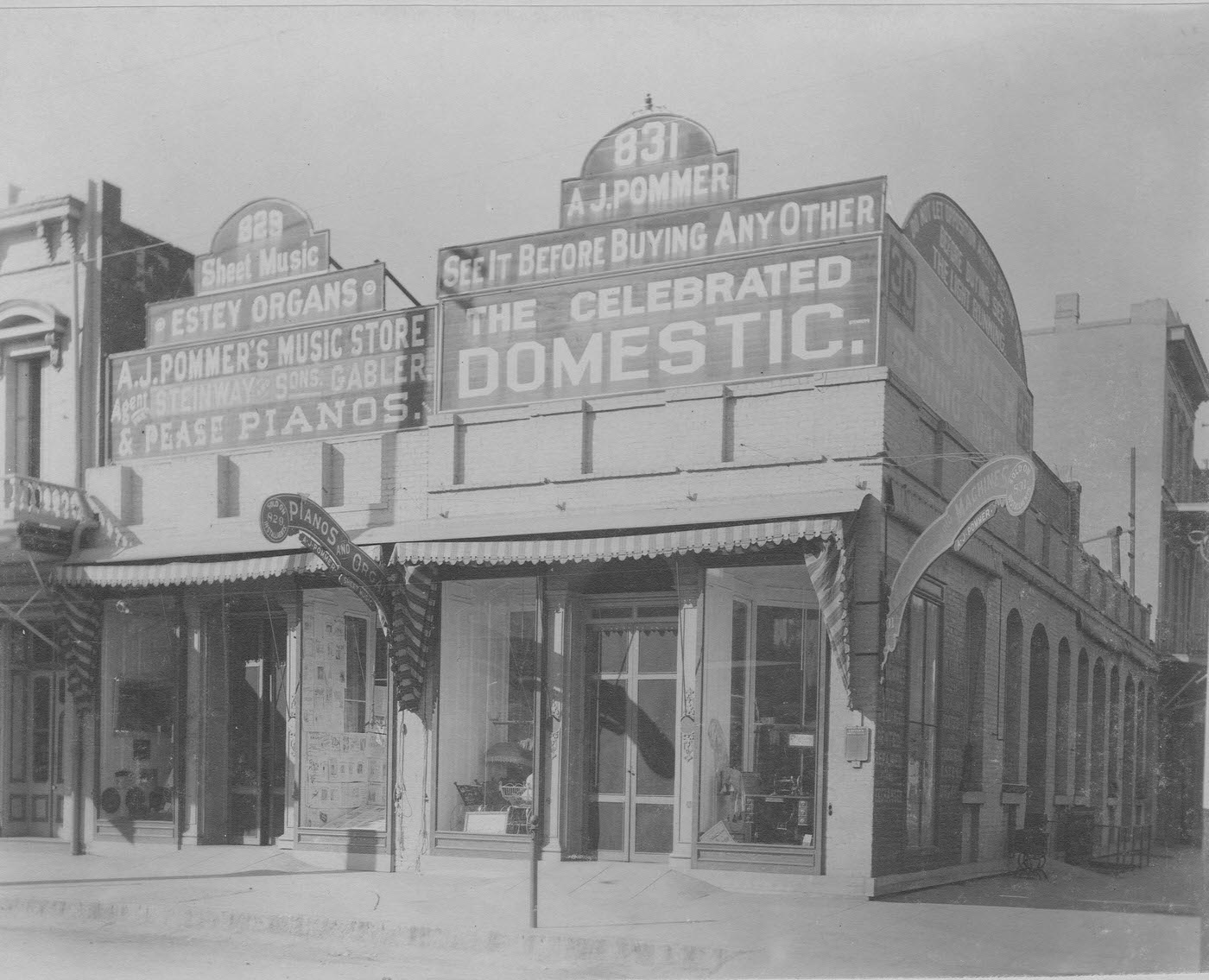 A. J. Pommer's building as it stood in 1896. Its 829 J St. location sold musical supplies, while sewing machines were offered at 831 J St. Both stores were at the northwest corner of Ninth and J streets.