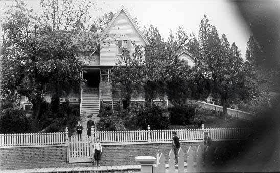 House with white picket fence, 1895