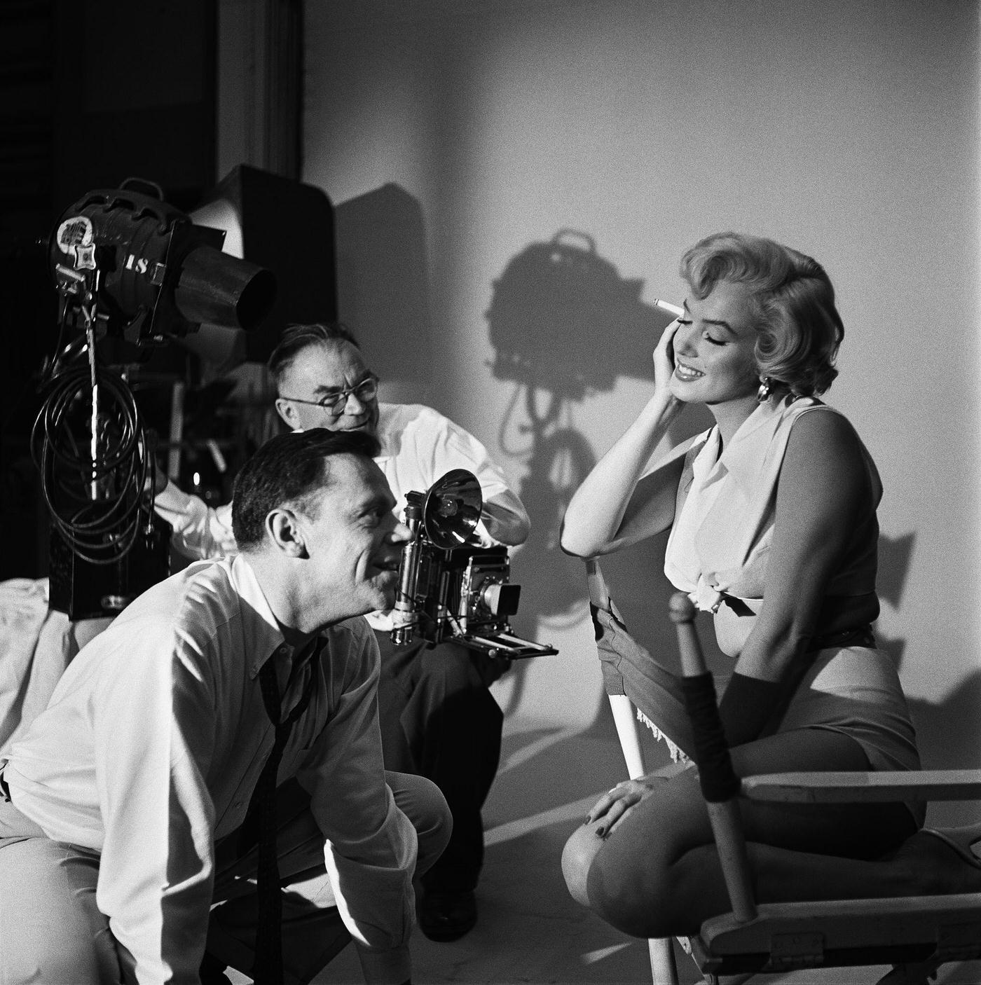 Marilyn Monroe with co-star Tom Ewell and photographer Frank Powolny in 1954 during the filming of "The Seven Year Itch"