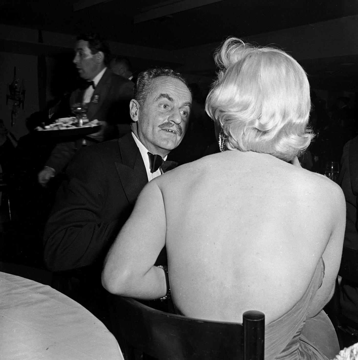 Marilyn Monroe with film producer Darryl Zanuck at the wrap party for the filming of "The Seven Year Itch" at Romanoff's Restaurant in 1954