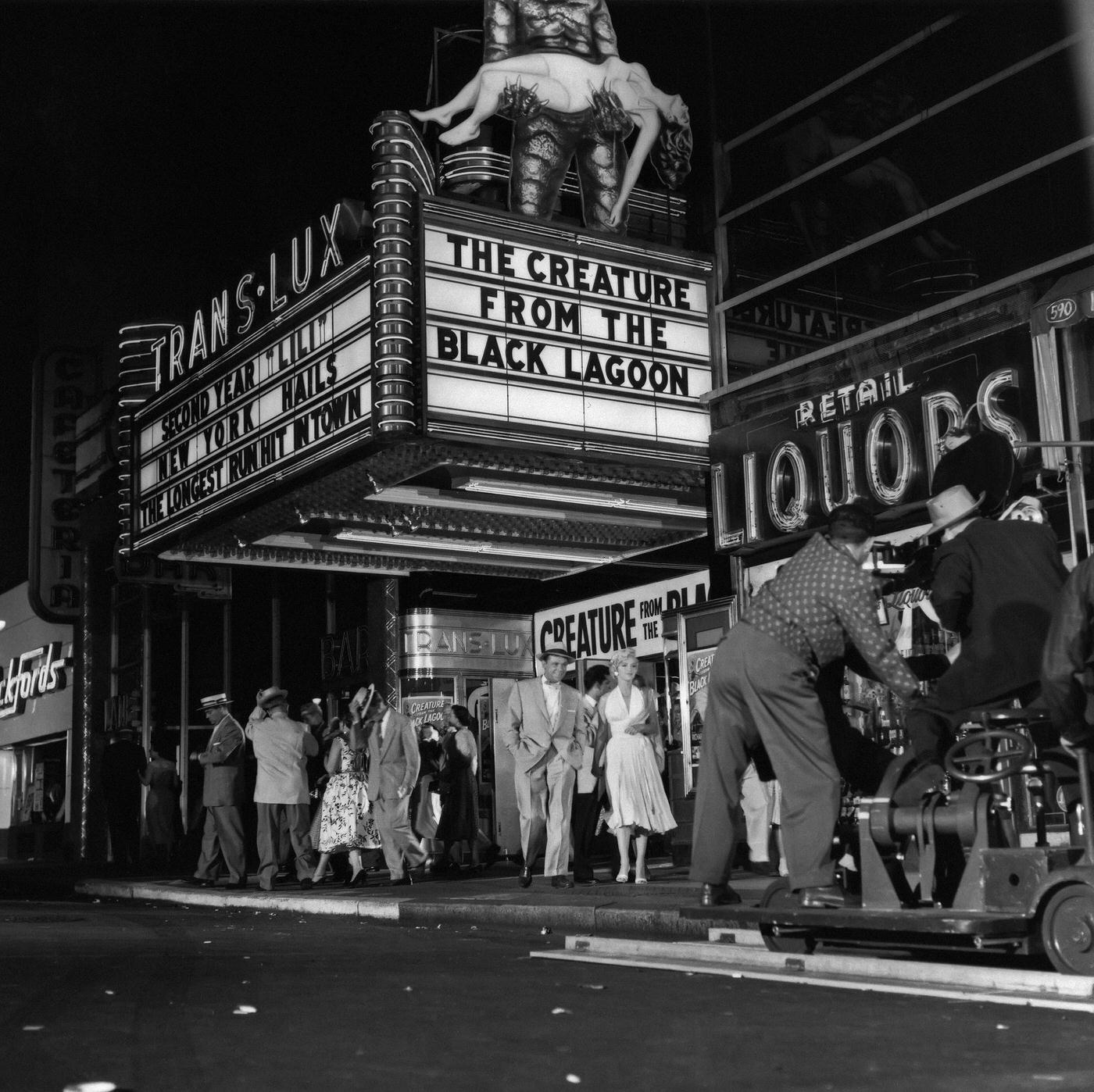 Marilyn Monroe walking with co-star Tom Ewell in front of the Trans-Lux Theater on the corner of 51st Street and Lexington Avenue