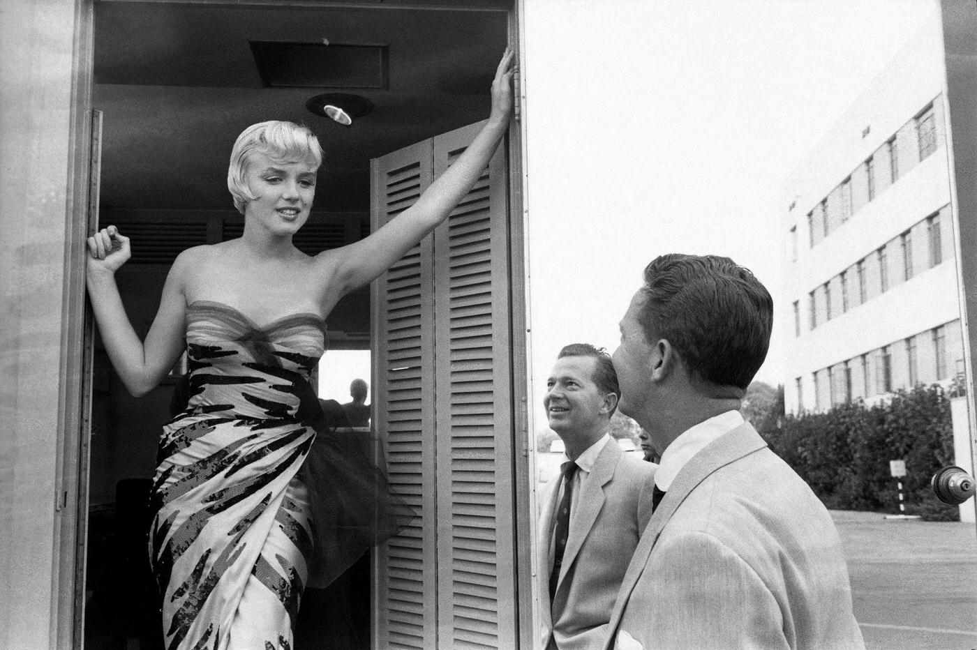 Marilyn Monroe stands in a doorway wearing a tiger-striped dress in 1954 during the filming of "The Seven Year Itch"