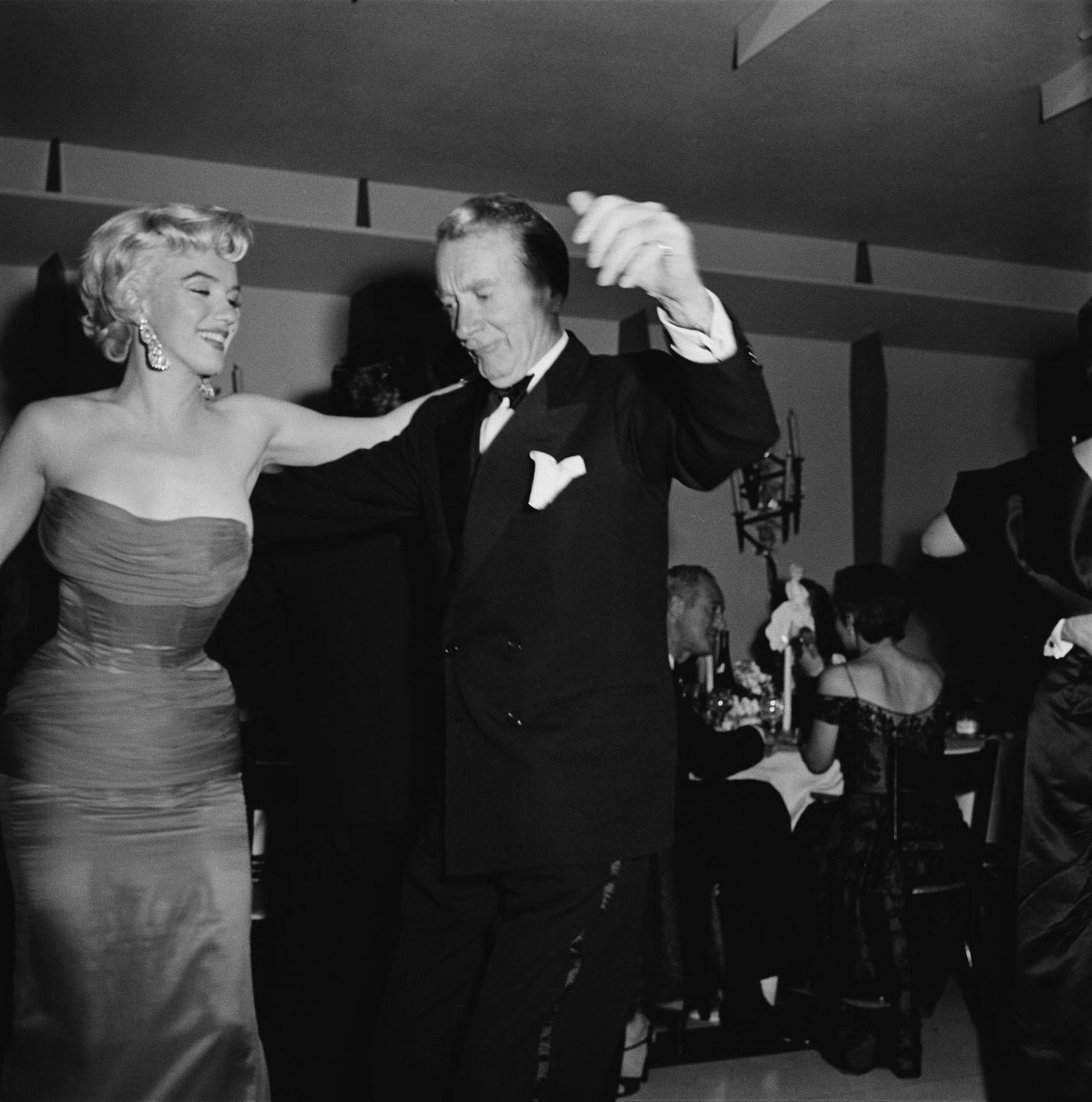 Marilyn Monroe dances with actor Clifton Webb at the wrap party for the filming of "The Seven Year Itch"