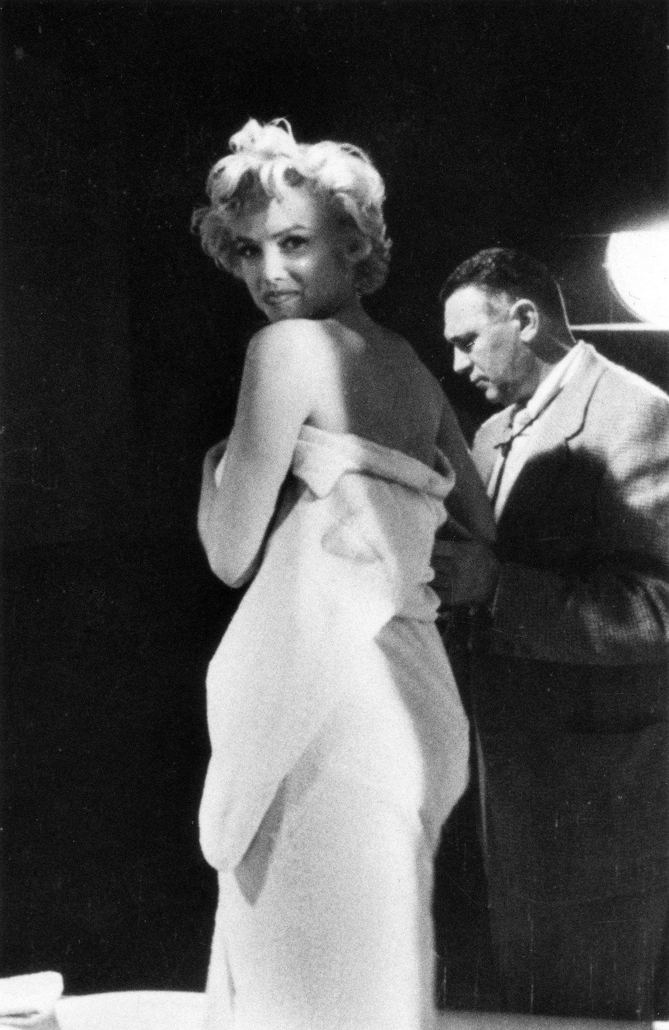 Marilyn Monroe prepares for a bathtub scene in 1954 on set with cinematographer Milton Krasner during the filming of "The Seven Year Itch" in Los Angeles