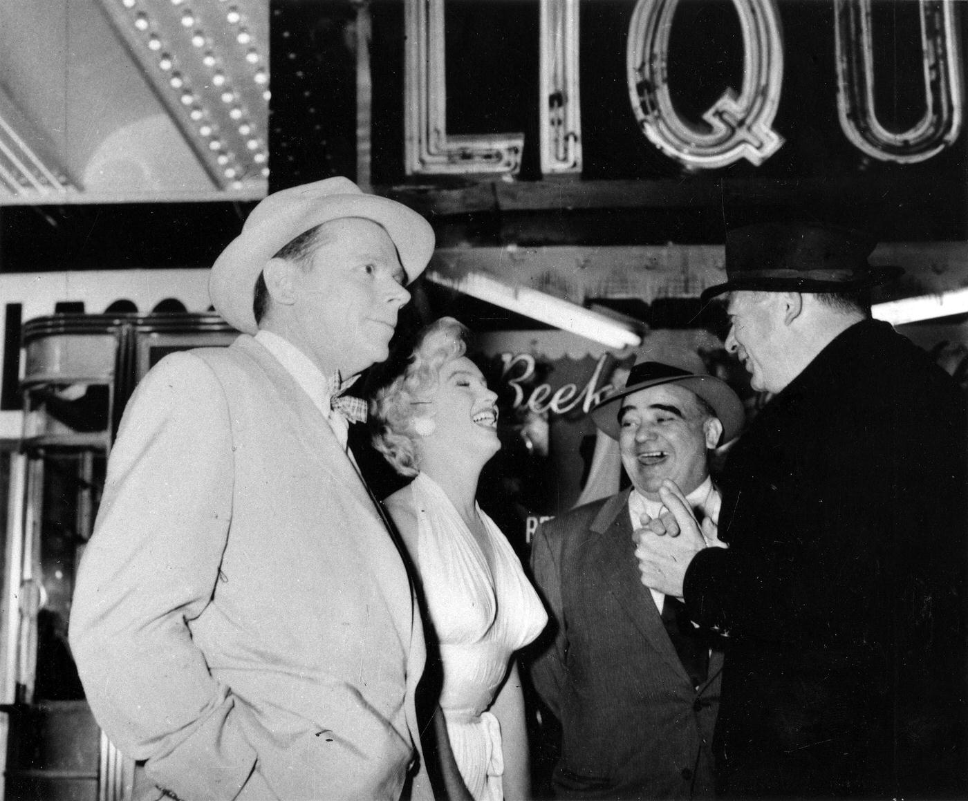 Marilyn Monroe with co-star Tom Ewell, production manager Johnny Graham, and director Billy Wilder on the corner of 51st Street and Lexington Avenue while filming the famous skirt-blowing scene for "The Seven Year Itch"