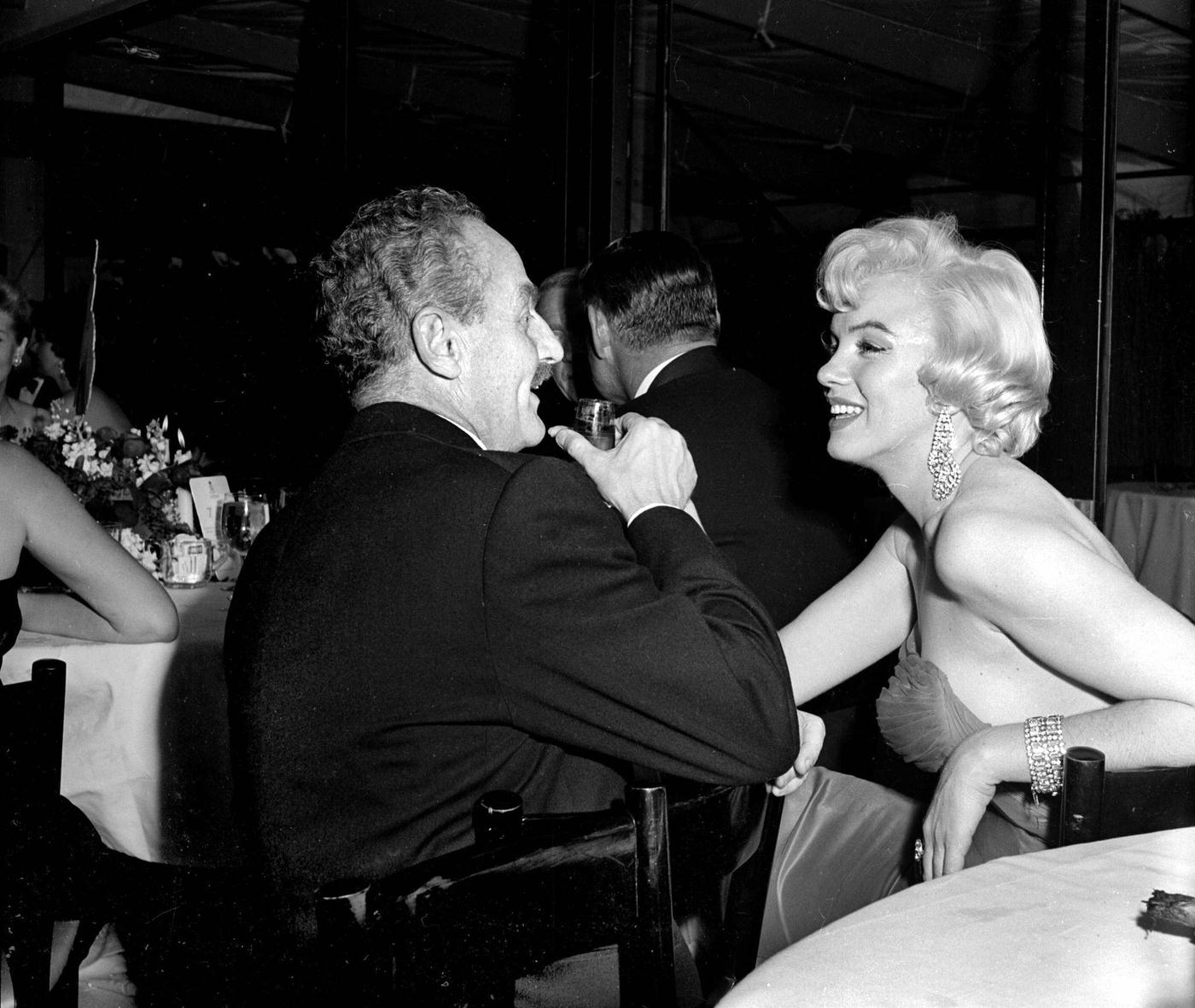 Marilyn Monroe with producer Darryl Zanuck at the wrap party for the filming of "The Seven Year Itch" at Romanoff's Restaurant in 1954