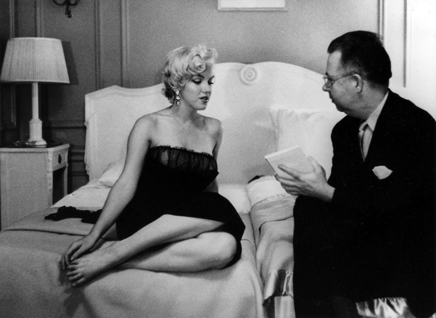 Marilyn Monroe speaks to a reporter at a press party for "The Seven Year Itch" in 1954 in New York