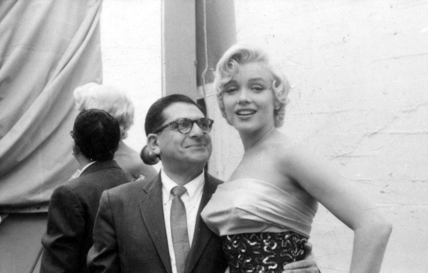 Marilyn Monroe with newspaper columnist Sidney Skolsky on set while working on the Dazzledent Toothpaste commercial sequence in 1954 for "The Seven Year Itch"