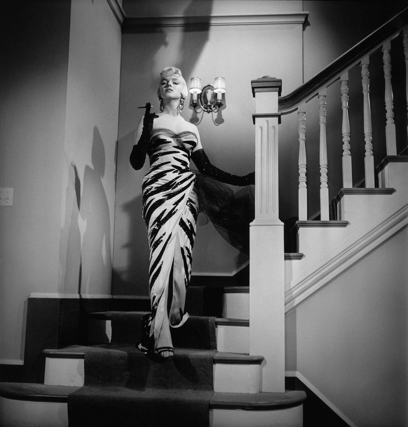 Marilyn Monroe descends a staircase wearing a tiger-striped strapless dress in 1954 during the filming of "The Seven Year Itch"
