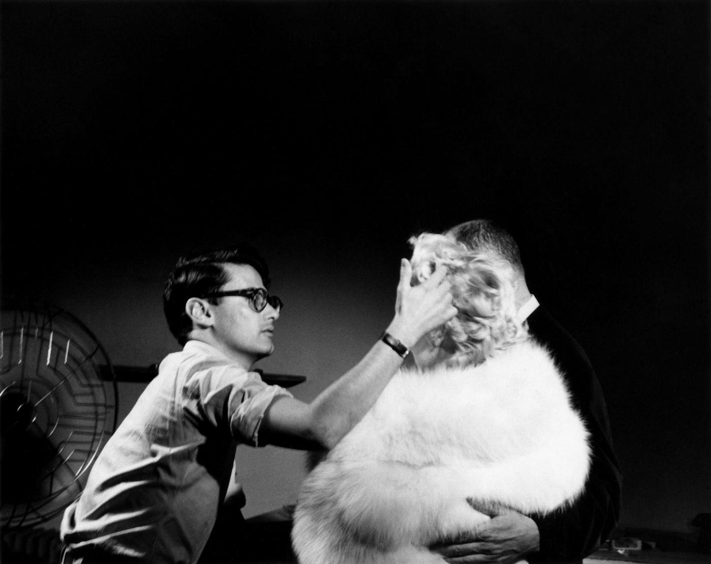 Richard Avedon works on Marilyn Monroe's hair for a publicity shoot with Director Billy Wilder for "The Seven Year Itch" in 1954 in New York