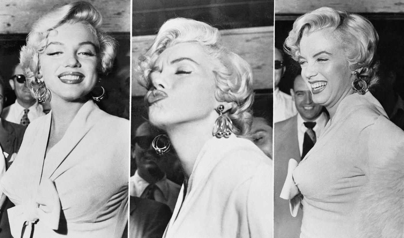 Marilyn Monroe stands over a subway grate with her white dress blowing with co-star Tom Ewell and a crowd of onlookers at the corner of 51st Street and Lexington Avenue during the filming of "The Seven Year Itch" in September, 1954