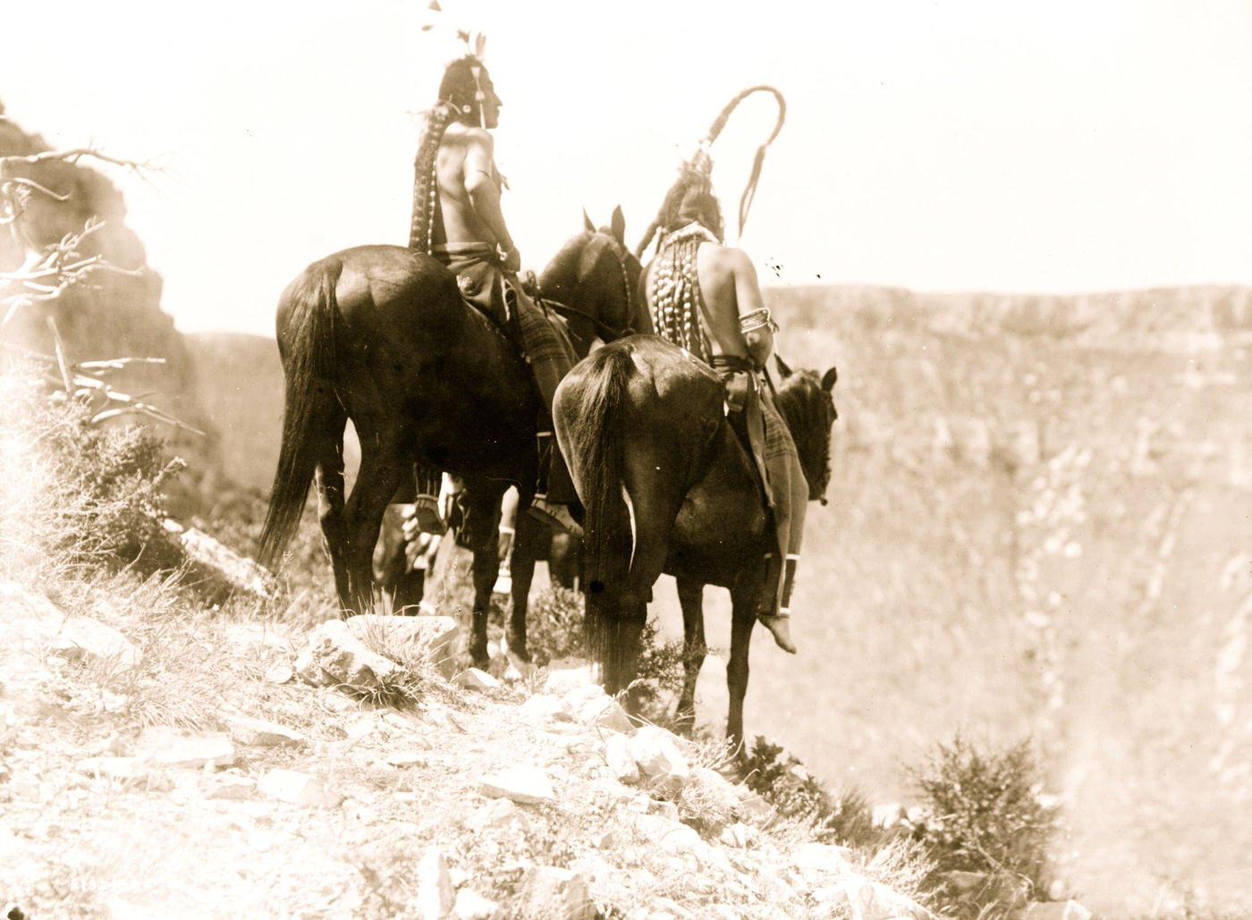 Packs The Hat and Which Way, two Crow Indians on horseback, Montana, 1905