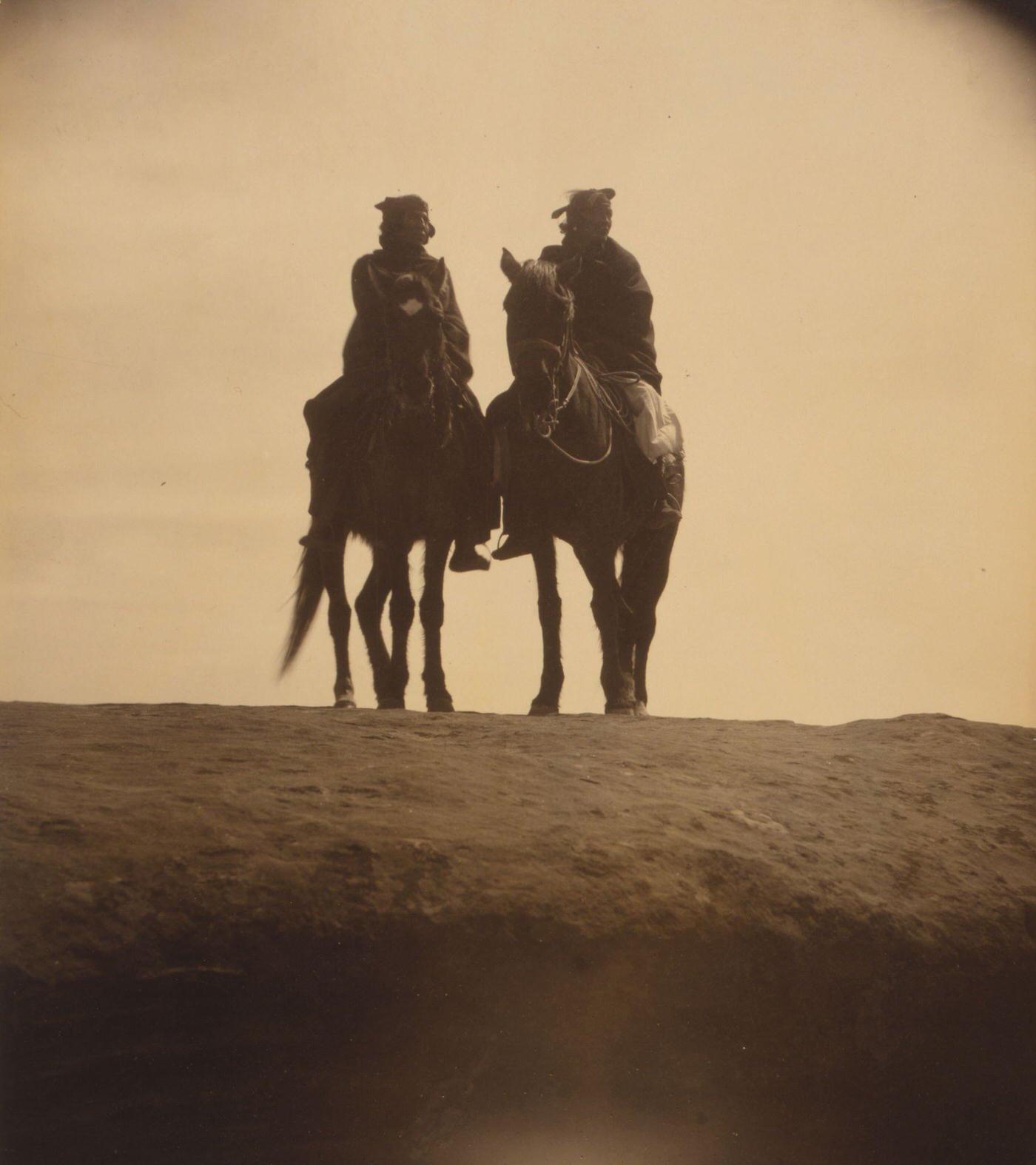 Two native American men mounted on horses, gazing off into the distance, 1904