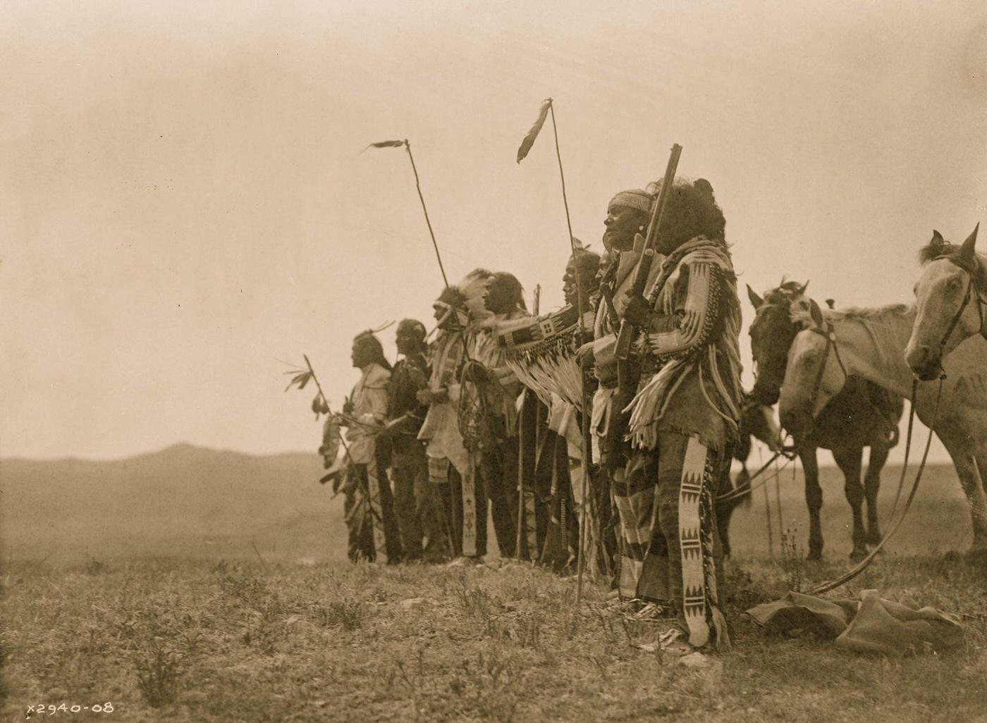 Atsina men on a hill with their horses, 1908