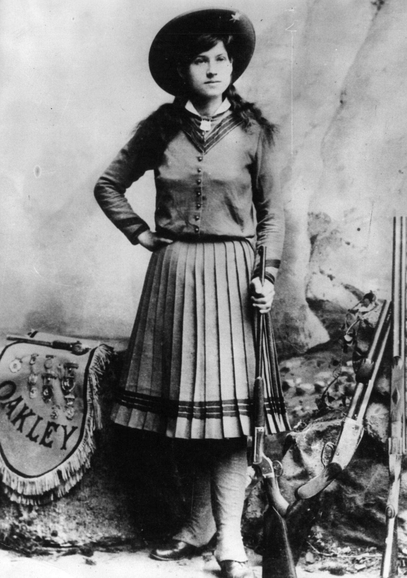 Annie Oakley, US rodeo star Annie Oakley (1860 - 1926), who was famous as a highly skilled trick shooter with the Buffalo Bill Wild West Show. One of her tricks was to shoot cigarettes from her husband's mouth.