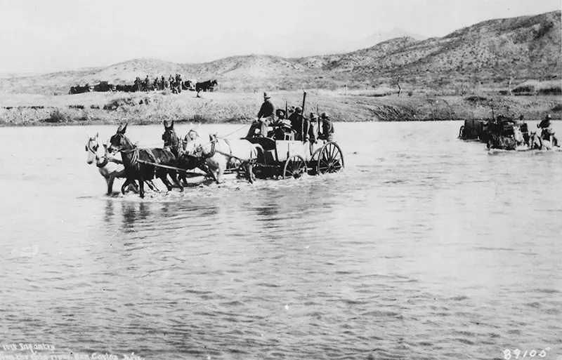 Buckboard wagons crossing Gila River near San Carlos, Arizona in 1885.