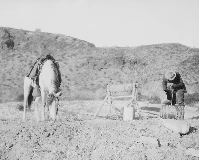 A rider and his horse refresh themselves from a desert well 30 miles north of Palomas, Arizona in 1907.