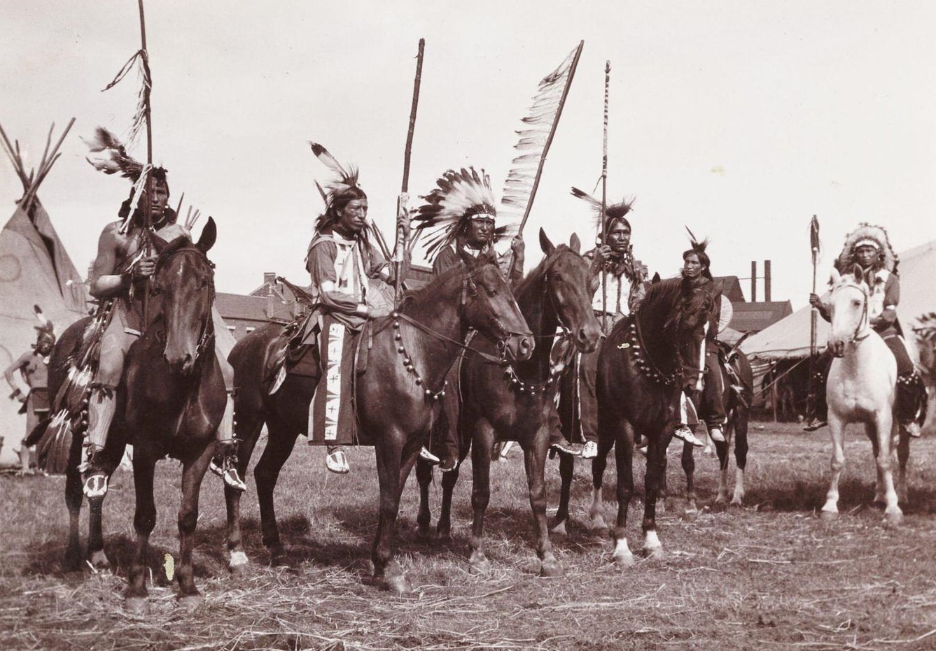 A snapshot photograph of a group of mounted Native Americans, taken by an unknown photographer in about 1905.