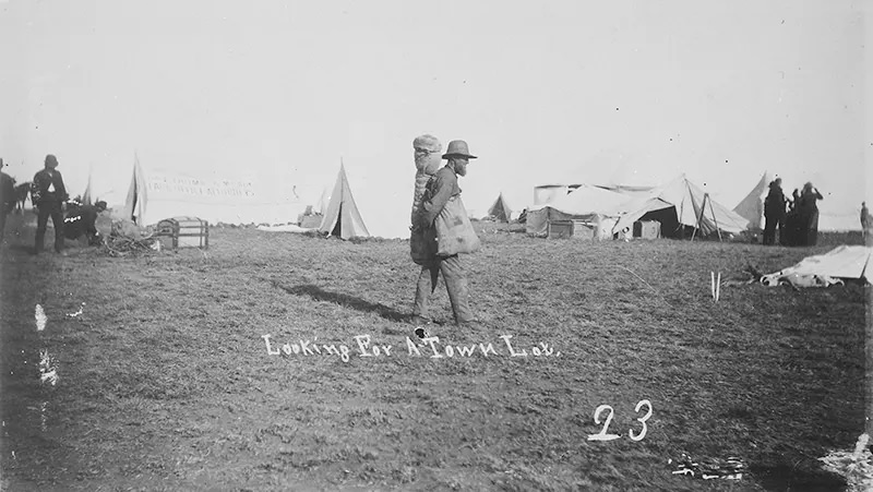 A new settler searches for a lot in the site of a new town in Guthrie, Oklahoma in 1889.