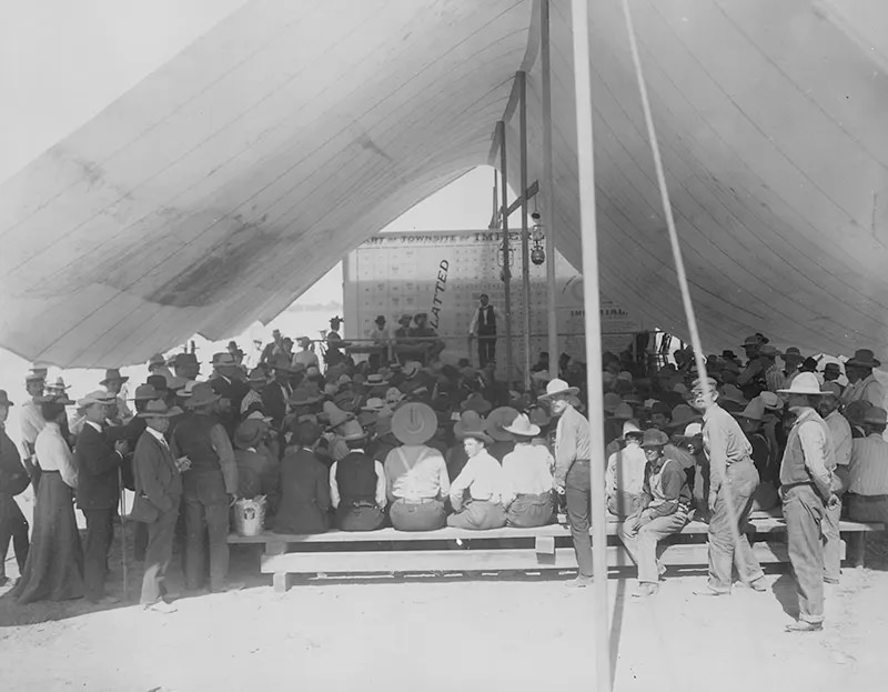 Land in a new territory is auctioned off in this tent in California in 1904.