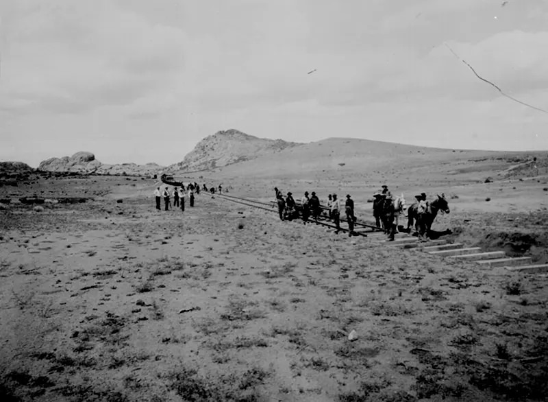 Men lay down track for a new railroad, connecting the wild frontier with the world in Arizona in 1898.