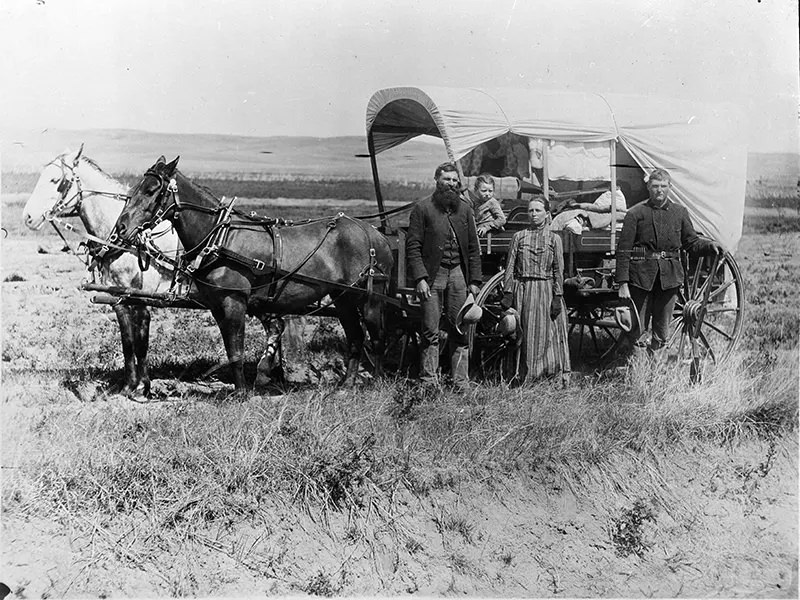 A family with their covered wagon during the Great Western Migration in Loup Valley, Nebraska in 1886.