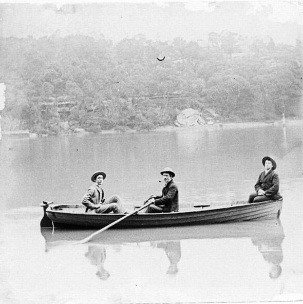 Three people in a rowing boat, possibly Sydney Harbour