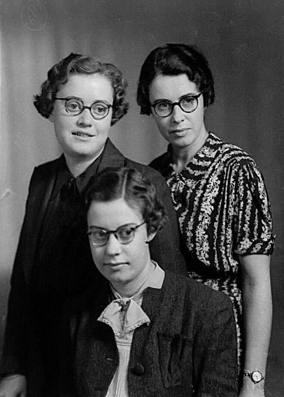 Group portrait of three women wearing glasses