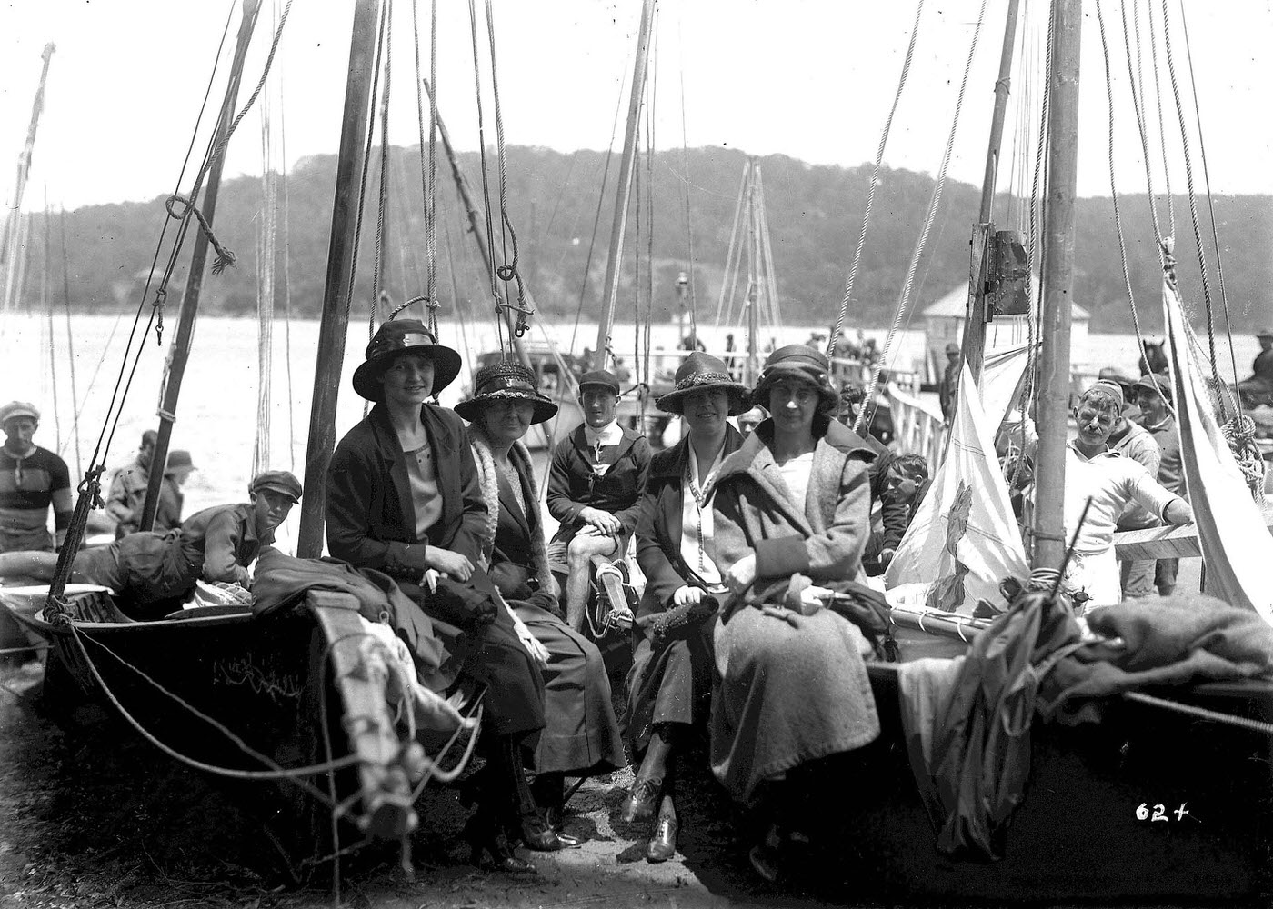 Women sitting on beached skiffs at the Pittwater Regatta