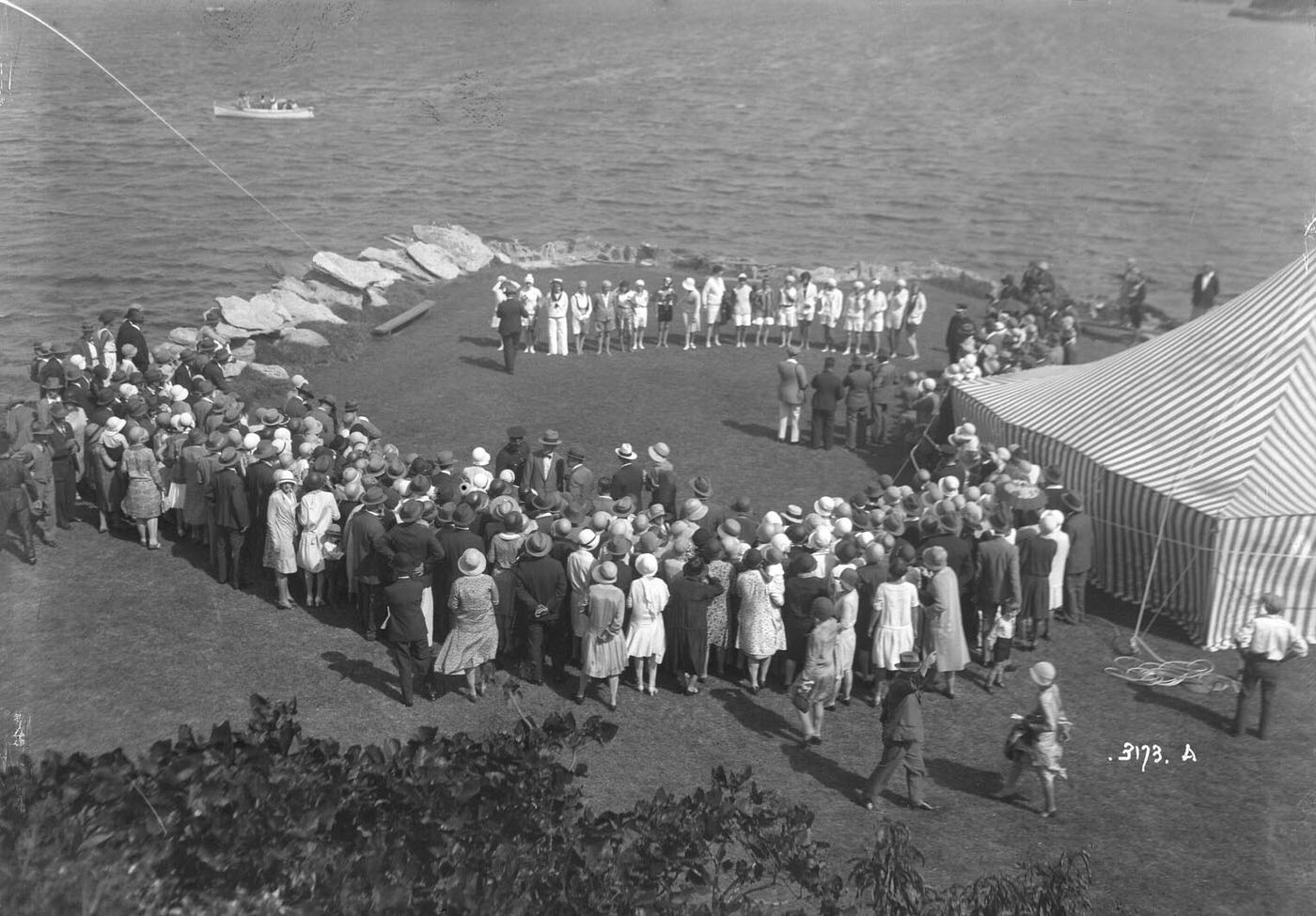 Spectators watching a presentation of Queen of the Harbour, Clark Island