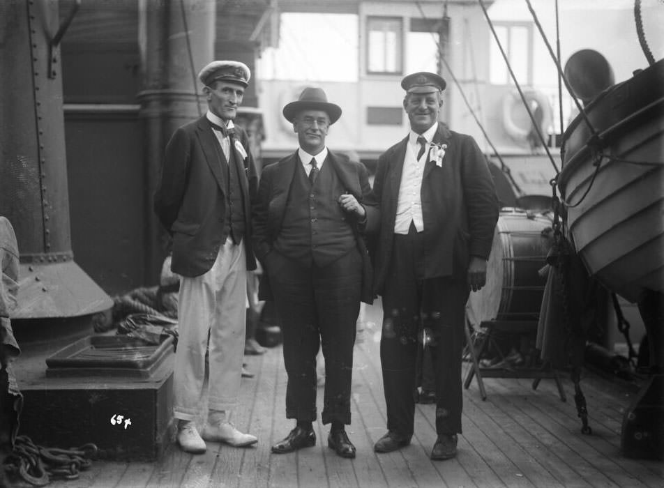 Mr John Roche (left), Mr F. J. S. Young (right) and an unidentified man onboard Naomi, Sydney Harbour